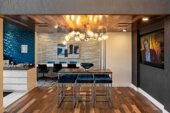 A dining room with a table and chairs and a chandelier